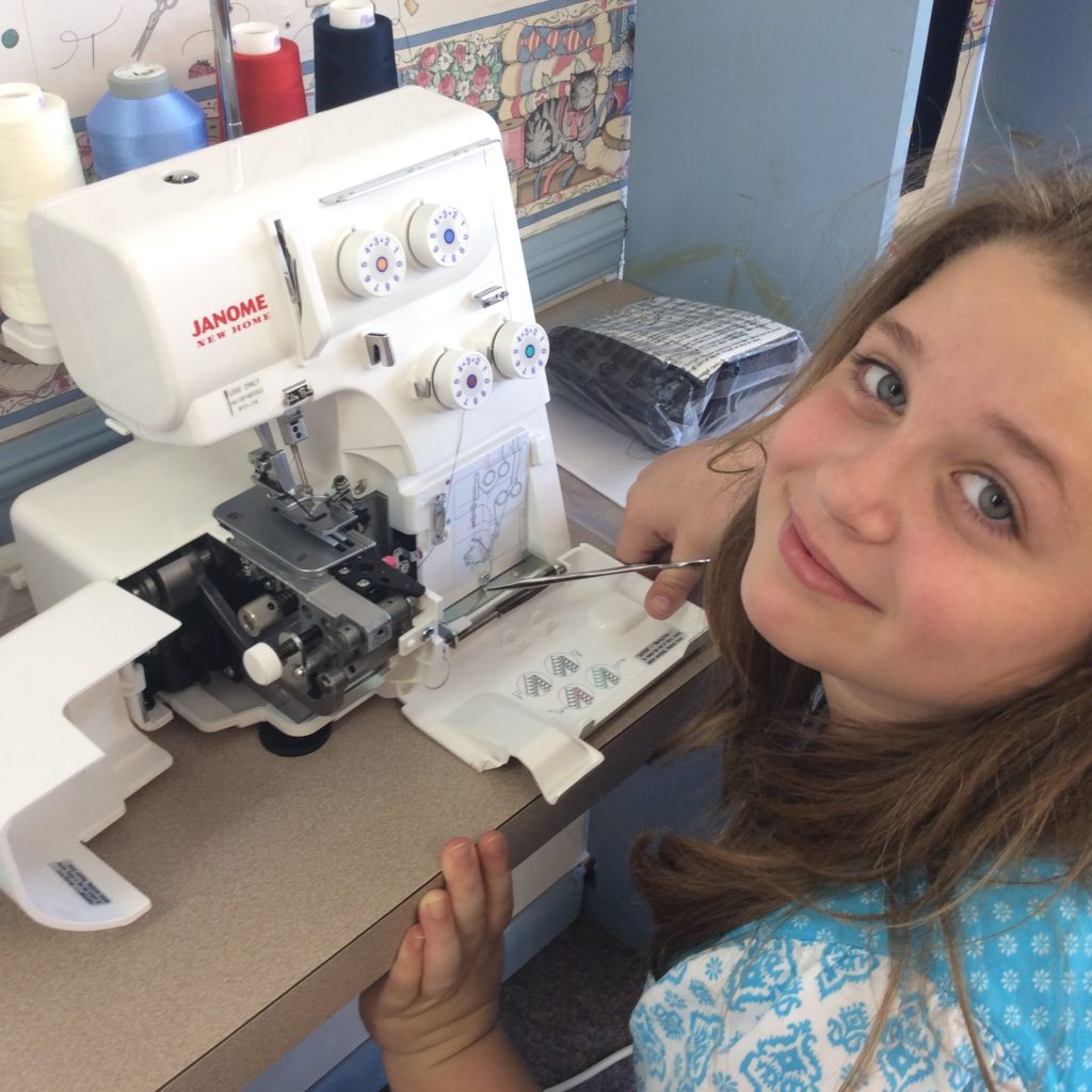 Leah, threading a serger.